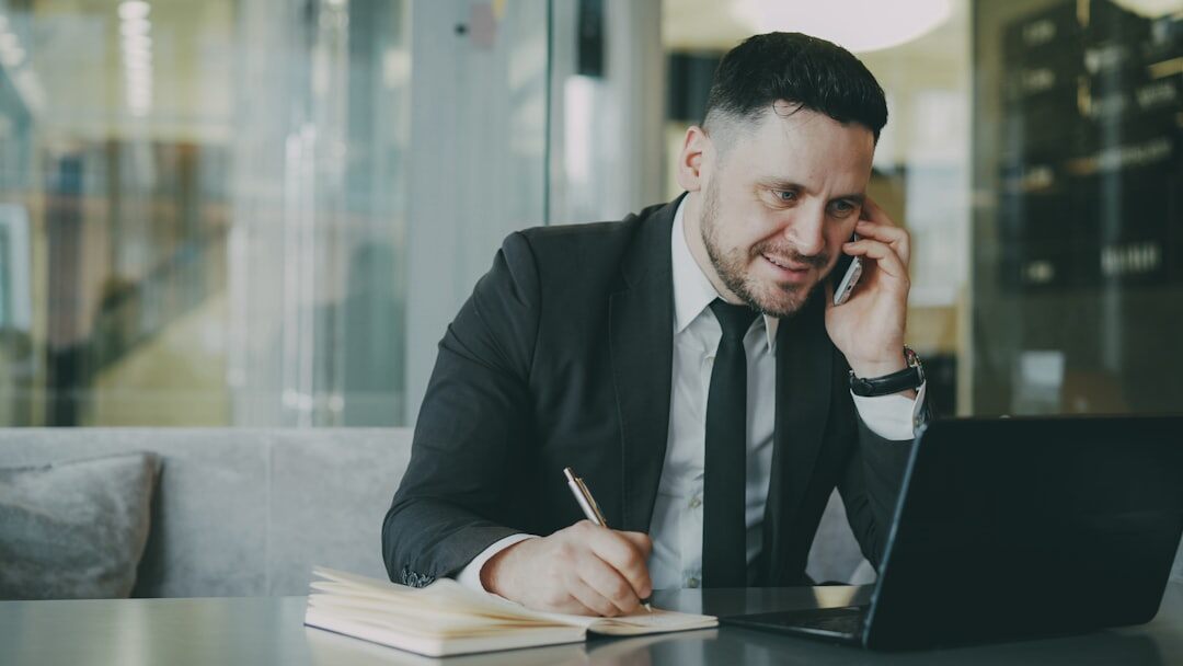 man writing notes