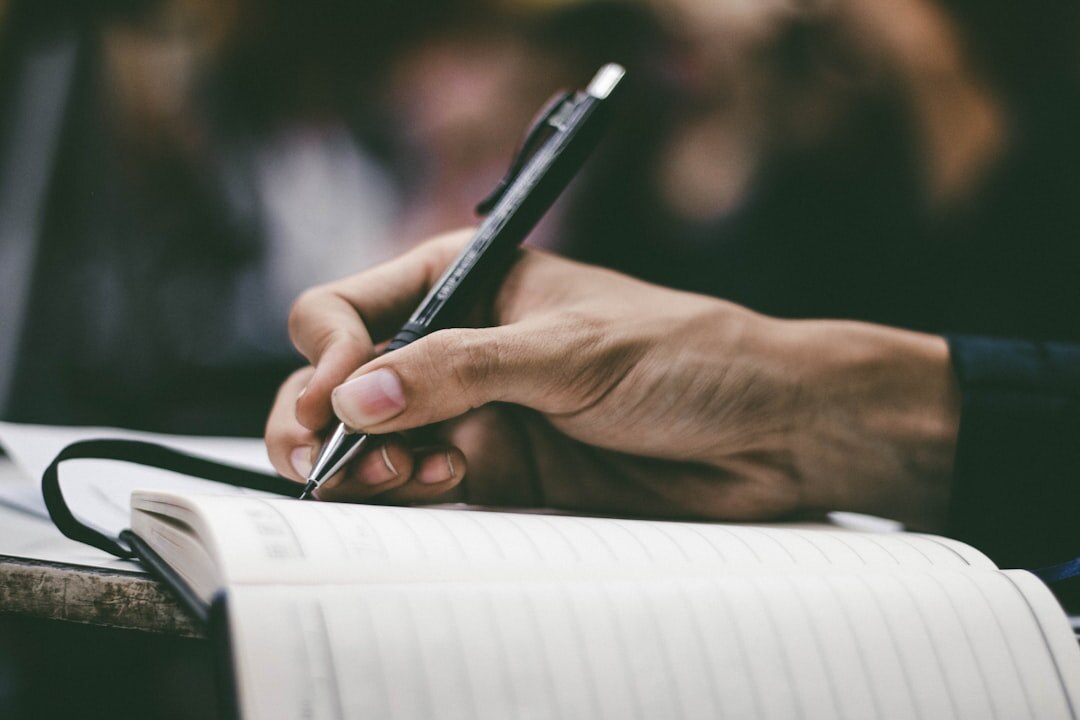 person writing in journal