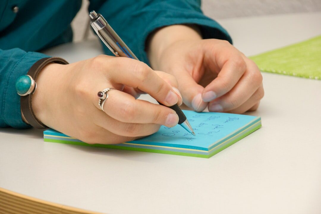 Close up of hands writing personal development goals in a journal